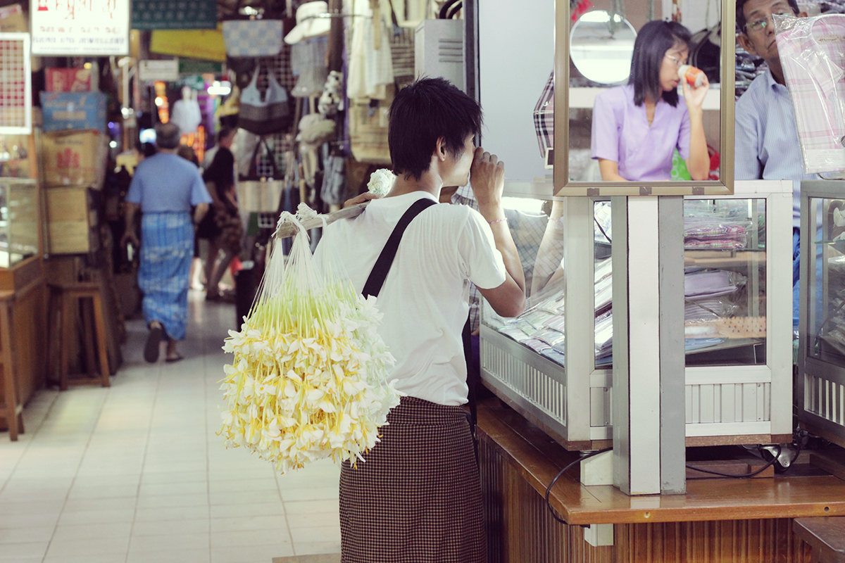 ジャスミンの花飾りを運ぶ売り子